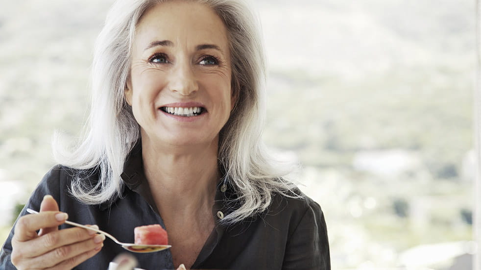 Breathing woman eating breakfast